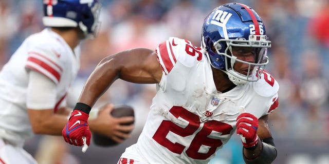 Saquon Barkley (26) of the New York Giants runs a route during a preseason game against the New England Patriots at Gillette Stadium Aug. 11, 2022, in Foxborough, Mass.