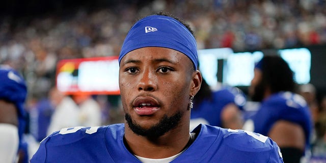 New York Giants' Saquon Barkley watches during the second half of a preseason game against the Cincinnati Bengals on Aug. 21, 2022, in East Rutherford, N.J.