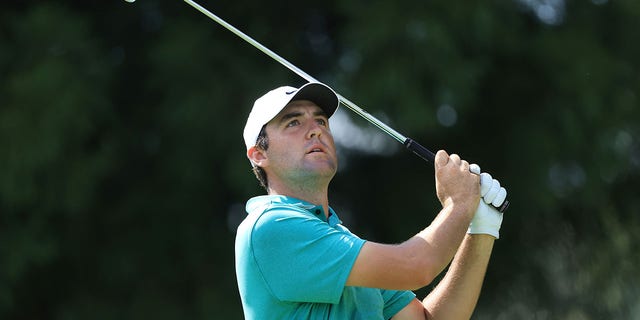Scottie Scheffler of the United States plays a shot on the 11th hole during the final round of the TOUR Championship at East Lake Golf Club on August 28, 2022, in Atlanta, Georgia.