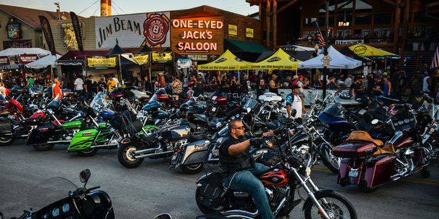 Motorcyclists drive down Main Street during the 80th Annual Sturgis Motorcycle Rally on August 7, 2020. That year, the event attracted nearly 500,000 visitors despite the threat of COVID-19.