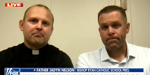 Fr. Jadyn Nelson (left) and parent Perry Olsen explained the benefits of a Catholic school education, which include continuing the values and morals that kids are taught in the home.