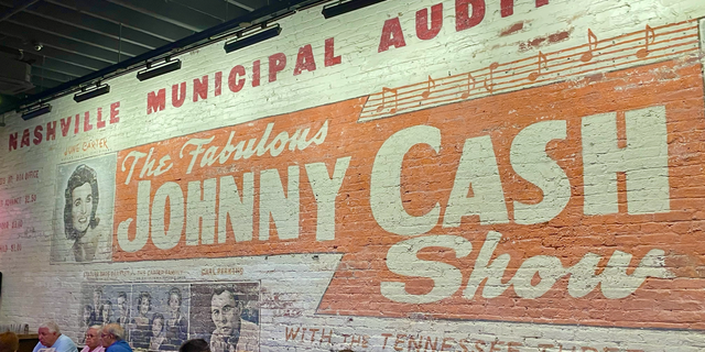 A mural inside Johnny Cash's Bar & BBQ in downtown Nashville promotes an early career performance by the legendary entertainer.