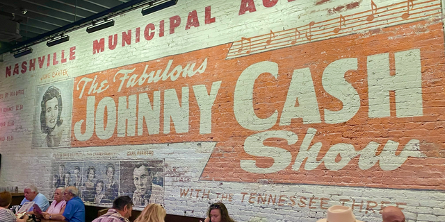 A mural inside Johnny Cash's Bar and BBQ in downtown Nashville promotes an early career performance by the legendary entertainer.