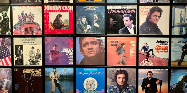 A small portion of a wall of album covers at the Johnny Cash Museum in Nashville. Across from the album covers is a display of vinyl records representing Cash's incredible 134 Billboard hit singles. 
