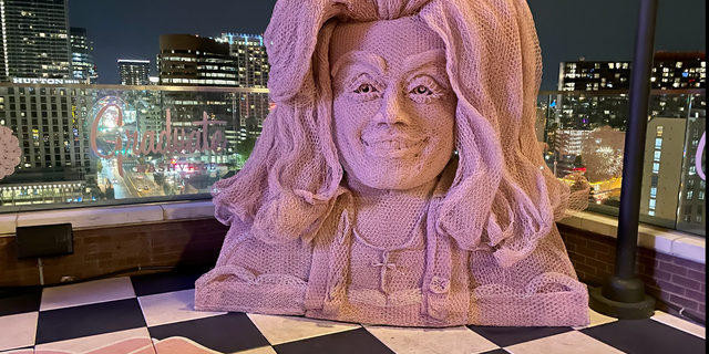 White Limozeen is a new Dolly Parton-themed rooftop bar at The Graduate hotel in Nashville. The decor includes a 10-foot-tall bust of Parton crafted from chicken wire by Tennessee artist Ricky Pittman. 