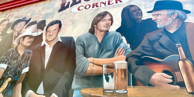 A mural of Music City icons outside Legends Corner, a longtime downtown Nashville honky tonk at the intersection of Broadway and Rep. John Lewis Way North. Pictured (front, from left) are Brad Paisley, Johnny Cash, Keith Urban and Merle Haggard.