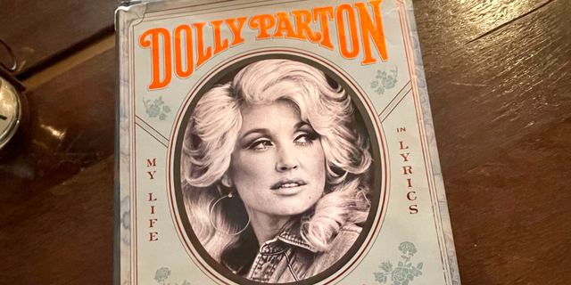 A copy of Dolly Parton's 2020 book, "Songteller: My Life in Lyrics," is kept in the lobby of the Hutton Hotel in Midtown Nashville. The hotel reflects the city's love of music. It has its own venue for live performances, called Analog, while musicians perform live in its lobby each day. 