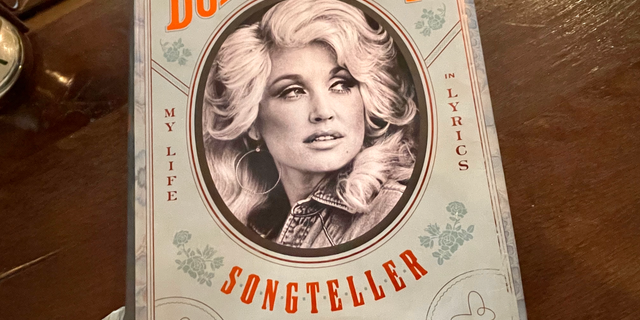 A copy of Dolly Parton's 2020 book, "Songteller: My Life in Lyrics," is kept in the lobby of the Hutton Hotel in Midtown Nashville. The hotel reflects the city's love of music. It has its own venue for live performances, called Analog, while musicians perform live in its lobby each day.