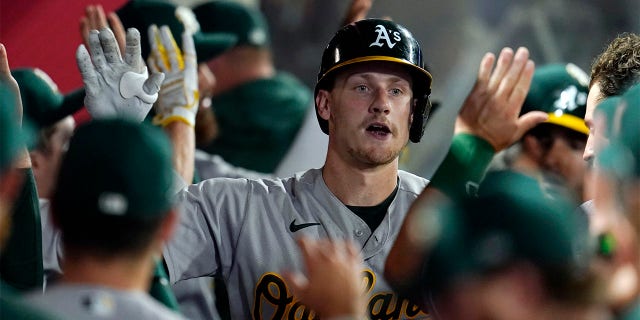 Oakland Athletics' Sean Murphy, center, is congratulated in the dugout after his two-run home run against the Los Angeles Angels during the sixth inning of a baseball game Wednesday, Aug. 3, 2022, in Anaheim, Calif.