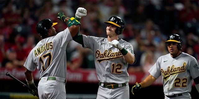 Oakland Athletics' Sean Murphy (12) celebrates his two-run home run with Elvis Andrus (17) during the sixth inning of the team's baseball game against the Los Angeles Angels on Wednesday, Aug. 3, 2022, in Anaheim, Calif. 