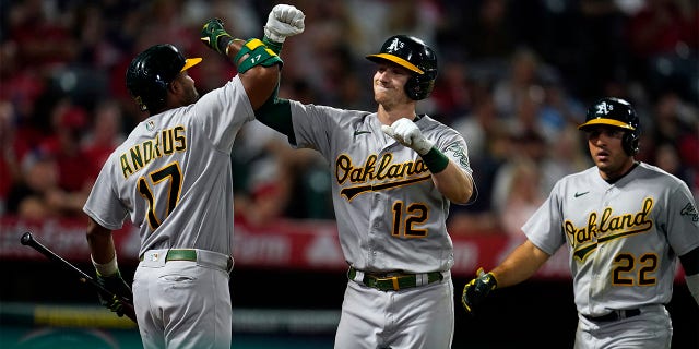 Oakland Athletics' Sean Murphy (12) celebrates his two-run home run with Elvis Andrus (17) during the sixth inning of the team's baseball game against the Los Angeles Angels on Wednesday, Aug. 3, 2022, in Anaheim, Calif.