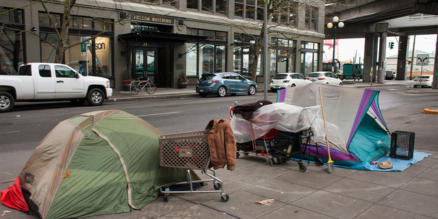 Photo of homeless encampment in Seattle, Washington, as car drives by