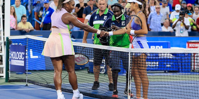 Serena Williams, left, shakes hands with Emma Raducanu of Britain after their match during the Western &amp; Southern Open tennis tournament on Aug. 16, 2022, in Mason, Ohio.