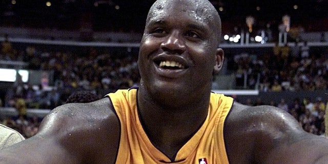 Laker center Shaquille O'Neal sits next to