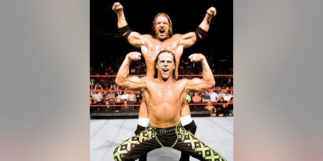 Shawn Michaels poses with the Triple H.