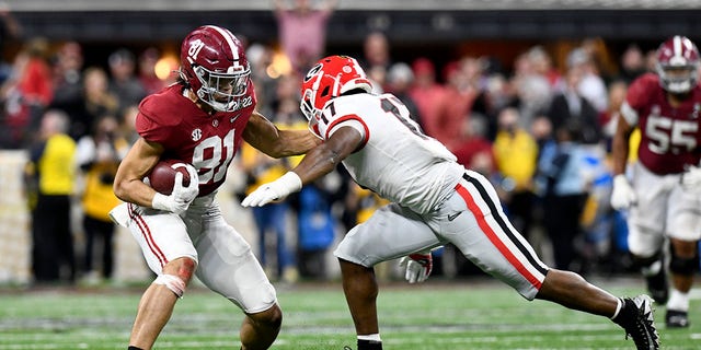 Alabama tight end Cameron Latu (81) is tackled by Georgia linebacker Nakobe Dean (17) in the College Football Playoff National Championship at Lucas Oil Stadium in Indianapolis, Indiana, on Jan. 10, 2022.