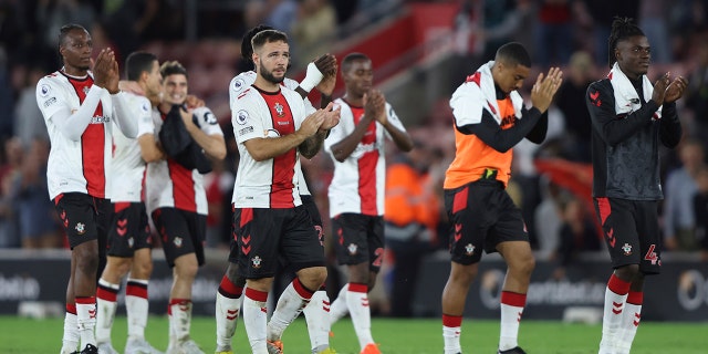 Southampton players applaud supporters at the end of the English Premier League soccer match between Southampton and Chelsea at St Mary's Stadium, Southampton, England, Tuesday, Aug. 30, 2022.