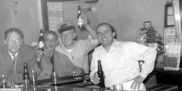 Jimmy Palermo (at right, in white shirt) serves patrons from behind the bar at Palermo's Tavern. The sports-themed pub in St. Louis stakes a strong claim as America's first-ever sports bar. 