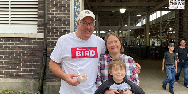 Republican candidate for Iowa attorney general Brenna Bird poses with her family at Iowa's State Fair.