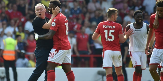 Nottingham Forest's head coach Steve Cooper with his player Cafu celebrate after the end of their soccer match against West Ham United at the City Ground in Nottingham, England, Sunday, Aug. 14, 2022.