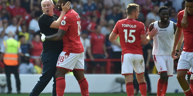 Nottingham Forest's head coach Steve Cooper with his player Cafu celebrate after the end of their soccer match against West Ham United at the City Ground in Nottingham, England, Sunday, Aug. 14, 2022.