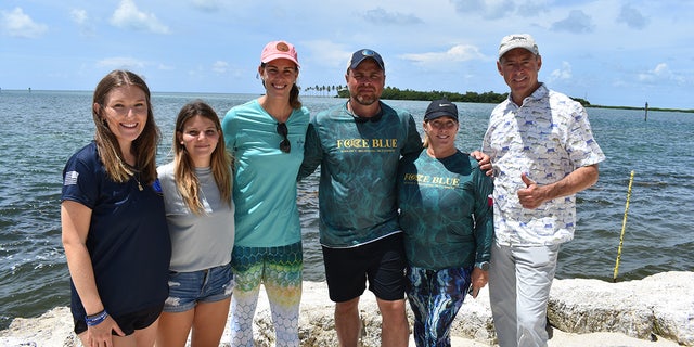 Army veterans Dan Henderson (third from right) and Suze MacDonald (second from right) join the Guy Harvey Ocean Foundation team at a conservation mission in Islamorada, Florida, in June 2022. Jessica Harvey (third from left) is shown in the pink hat and teal shirt. 
