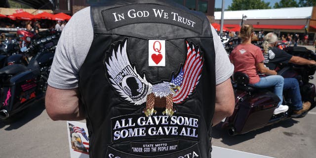 Dane Senser walks on Main Street during the 80th Annual Sturgis Motorcycle Rally on August 8, 2020, in Sturgis, S.D., wearing a POW-MIA vest. The rally traces its roots to founder Pappy Hoel's embrace of America's World War II veterans.