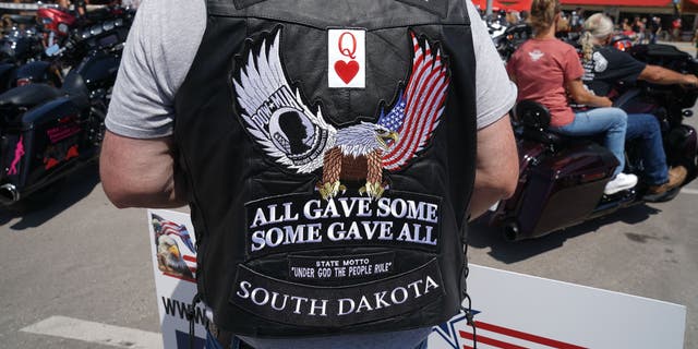Dane Senser walks on Main Street during the 80th Annual Sturgis Motorcycle Rally on August 8, 2020, in Sturgis, S.D., wearing a POW-MIA vest. The rally traces its roots to founder Pappy Hoel's embrace of America's World War II veterans.