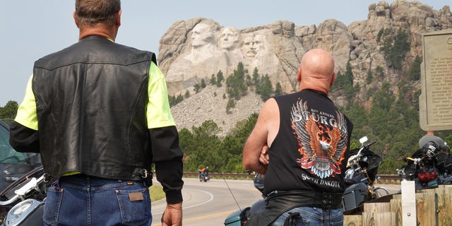 Bikers stop to take in Mt. Rushmore on Aug. 9, 2021. Every August, hundreds of thousands of motorcycling enthusiasts are attracted to the southwest corner of South Dakota for the annual Sturgis Motorcycle Rally. 