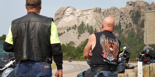 Bikers stop to take in Mt. Rushmore on Aug. 9, 2021. Every August, hundreds of thousands of motorcycling enthusiasts are attracted to the southwest corner of South Dakota for the annual Sturgis Motorcycle Rally.