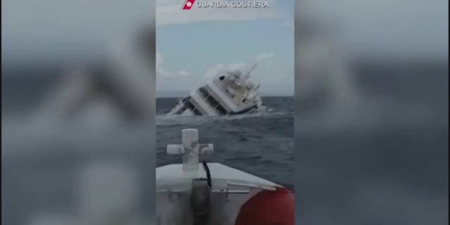 The yacht listing heavily to starboard before submerging underwater.