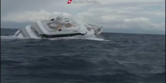 The yacht is shown listing heavily to starboard.