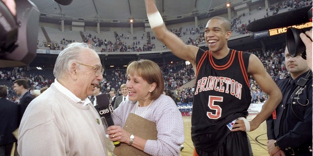 Guard Sydney Johnson and coach Pete Carril of the Princeton Tigers celebrate after a game against the UCLA Bruins at the RCA Dome in Indianapolis, Indiana. 