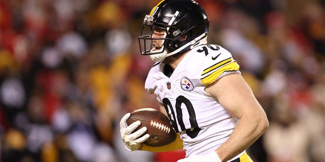 Pittsburgh Steelers' TJ Watt #90 recovers the ball and runs for a touchdown in the second quarter of the game against the Kansas City Chiefs during the NFC Wild Card Playoff game at Arrowhead Stadium on January 16, 2022 in Kansas City, Missouri. 