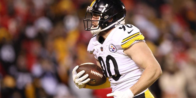 Pittsburgh Steelers' TJ Watt #90 recovers the ball and runs for a touchdown in the second quarter of the game against the Kansas City Chiefs during the NFC Wild Card Playoff game at Arrowhead Stadium on January 16, 2022 in Kansas City, Missouri.