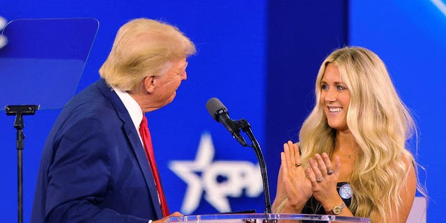 Former U.S. President Donald Trump is joined onstage by SEC champion swimmer Riley Gaines at the Conservative Political Action Conference (CPAC) in Dallas, Texas, U.S., August 6, 2022. 