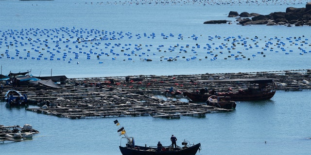 A boat moves through the water at the 68-nautical-mile scenic spot, the closest point in mainland China to the island of Taiwan, in Pingtan in southeastern China's Fujian Province, Friday, Aug. 5, 2022.