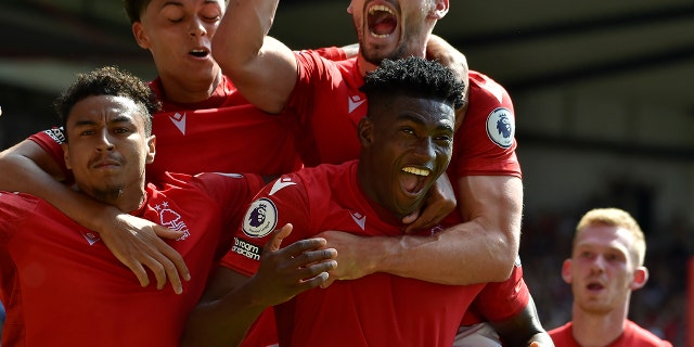 Nottingham Forest's Taiwo Awoniyi, center, celebrates with his teammates after scoring against West Ham at the City ground in Nottingham, England, Sunday, Aug. 14, 2022.
