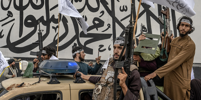 Taliban fighters in truck with guns