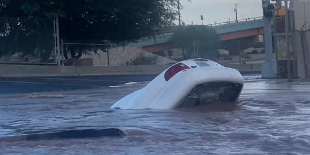 Later in the footage, the car is seen almost completely submerged in the sinkhole in El Paso, Texas.