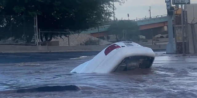 Later in the footage, the car is seen almost completely submerged in the sinkhole in El Paso, Texas.