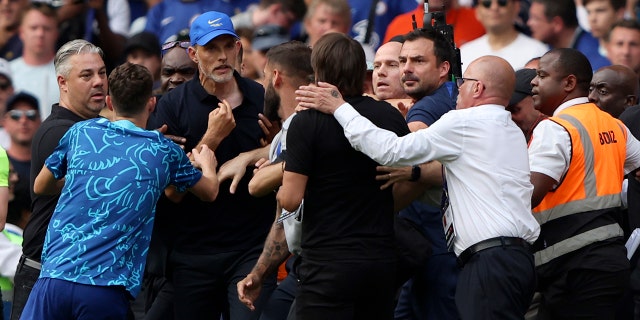 Chelsea's head coach Thomas Tuchel argues with Tottenham's head coach Antonio Conte during their teams' match at Stamford Bridge Stadium in London, Sunday, Aug. 14, 2022.