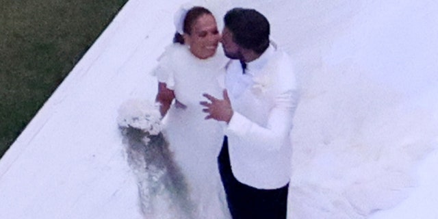 Ben Affleck and Jennifer Lopez embrace in a photo taken at their wedding.