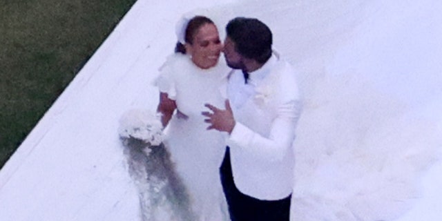 Ben Affleck and Jennifer Lopez embrace in a photo taken at their wedding.