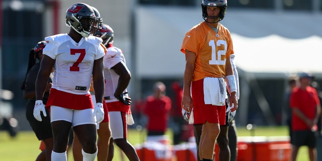 Tampa Bay Buccaneers quarterback Tom Brady (12) and running back Leonard Fournette (7) participate in training camp at AdventHealth Training Center in Tampa, Florida, on July 30, 2022.