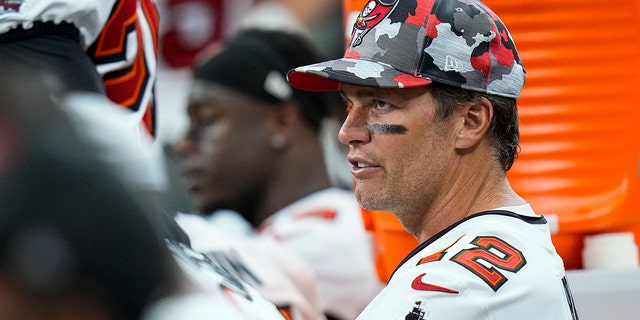 Tampa Bay Buccaneers quarterback Tom Brady sits on the bench during the Colts game in Indianapolis, Saturday, Aug. 27, 2022.