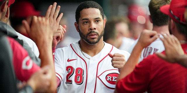 Cincinnati Reds' Tommy Pham, #28, celebrates with teammates after scoring on a Donovan Solano double during the third inning of a baseball game against the Miami Marlins, Monday, July 25, 2022, in Cincinnati.