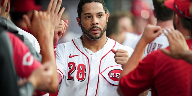Cincinnati Reds' Tommy Pham, #28, celebrates with teammates after scoring on a Donovan Solano double during the third inning of a baseball game against the Miami Marlins, Monday, July 25, 2022, in Cincinnati.