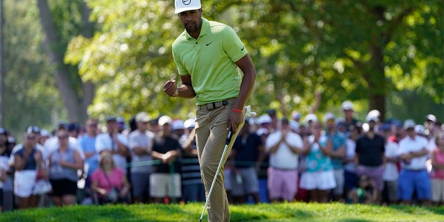 Tony Finau reacts after making his putt for par on the ninth green during the final round of the Rocket Mortgage Classic golf tournament, Sunday, July 31, 2022, in Detroit.