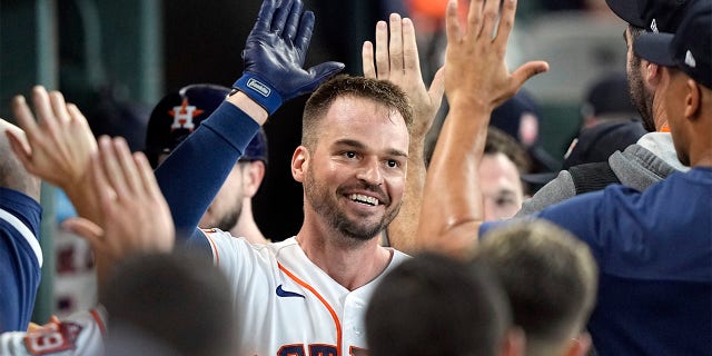 Houston Astros' Trey Mancini celebrates with teammates in the dugout after hitting a two-run home run against the Boston Red Sox during the second inning of a baseball game Wednesday, Aug. 3, 2022, in Houston.